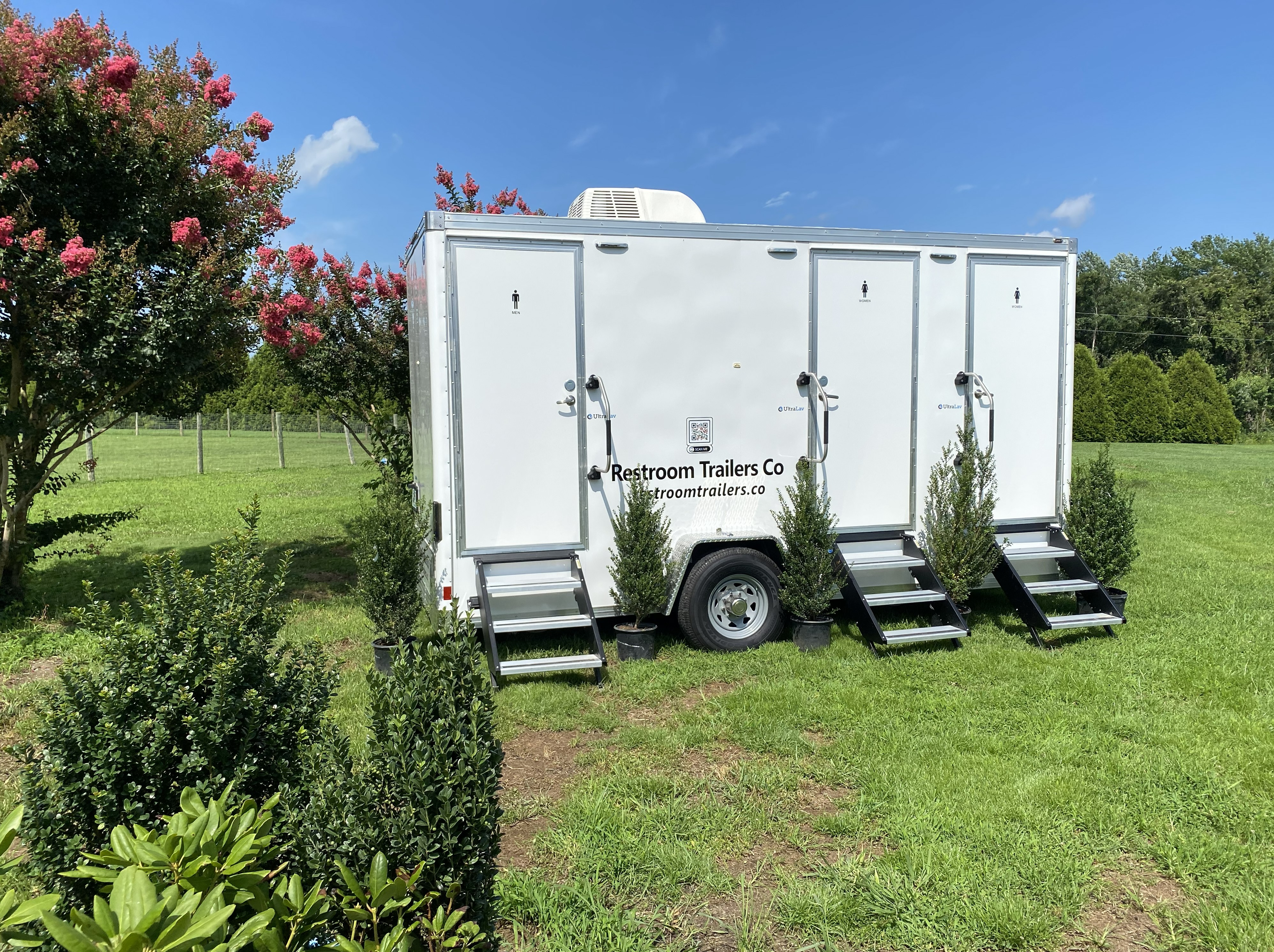 Restroom trailer setup in outdoor event setting